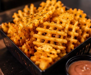 Illustrative basket of golden waffle fries